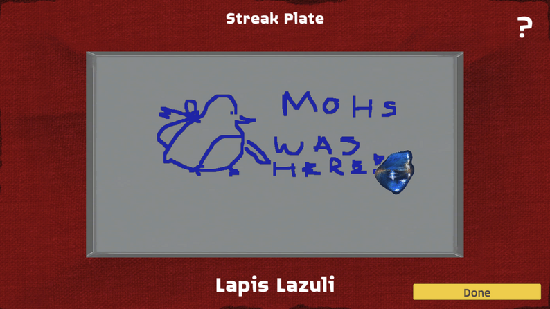 The streak plate scene from Rock Hunting with Mohs. Someone has drawn Mohs, and written 'Mohs was here'.
